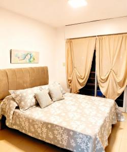 En eller flere senge i et værelse på Village Coast