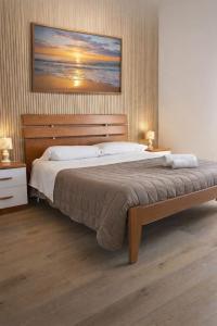 a bedroom with a large bed and two night stands at Nichi & Matti Iemmolo's Guest House in Campofelice di Roccella