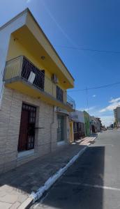 a building with balconies on the side of a street at Casa privada no Centro in São Gabriel