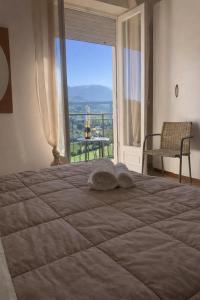 a bedroom with a large bed with a large window at Nichi & Matti Iemmolo's Guest House in Campofelice di Roccella