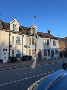 a row of houses on a city street at Studio with en suite, compact and comfortable for 1-2 people in Luton +9 photos