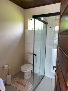 a bathroom with a toilet and a glass shower at Ebenezer in Benedito Novo +53 photos
