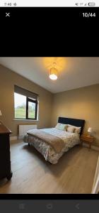 a bedroom with a large bed and a window at Seaview House in Donegal