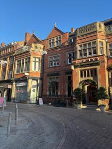 an empty street in front of a brick building at The Luxe Haven Penthouse - Sleeps 4 Apartment Nottingham City Centre in Nottingham