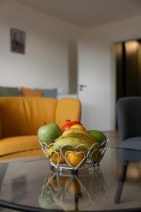 a bowl of fruit on a glass table at Horský sen - Mountain Dream Apartment B1 in Špičák +22 photos