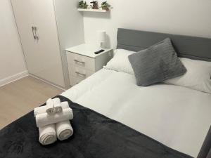 a bedroom with a bed with two rolled towels on it at Pats Place in Liverpool +5 photos
