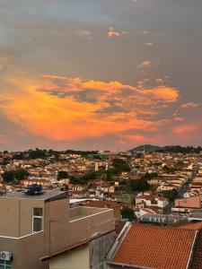 a view of a city at sunset at Pousada Sete Colinas in Bragança Paulista