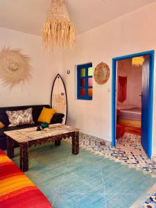 a living room with a couch and a table at Global Surf GuestHouse in Sidi Kaouki