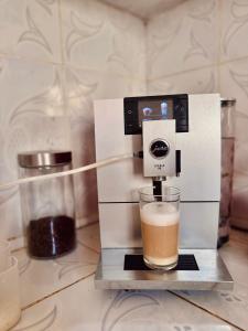 a coffee maker with a glass on a counter at Global Surf GuestHouse in Sidi Kaouki +18 photos