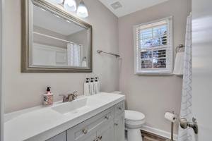 a white bathroom with a sink and a toilet at Red Ranch Bring Your Dogs! Fenced Yard in Clarksville +28 photos