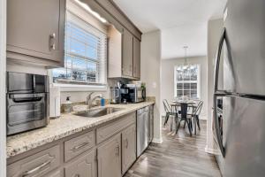 a kitchen with stainless steel appliances and a table at Red Ranch Bring Your Dogs! Fenced Yard in Clarksville