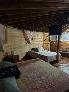 a bedroom with two beds and a tv in it at Cabaña Privada Pachamama Ancestral in Medellín +10 photos