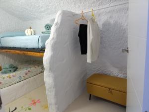 a bedroom with a bed in a wall with towels at Cueva Doña Bona in Bácor +46 photos