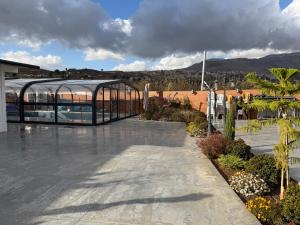 a glass building with a swimming pool in it at Country breeze park in Majdal Shams