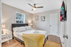 a bedroom with a bed and a ceiling fan at Red Ranch Bring Your Dogs! Fenced Yard in Clarksville