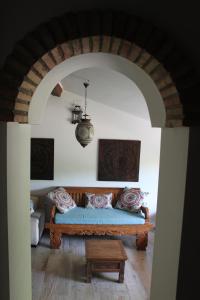 a living room with a blue couch and a table at Cortijo la Noria II in Puebla de Don Fadrique