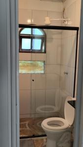 a bathroom with a toilet and a window at Sol&Mar Paraty Mirim in Paraty +12 photos