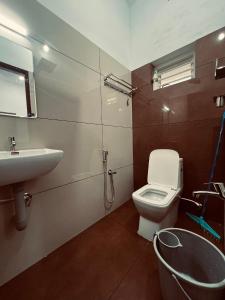 a bathroom with a toilet and a sink at Green Villa Chirackal Gardens in Trichūr +27 photos