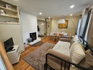 a living room with a couch and a dining room at Park House Mada in Rockville