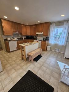 a large kitchen with wooden cabinets and a table at Park House Mada in Rockville