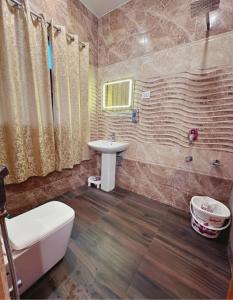 a bathroom with a sink and a toilet and a tub at Faizzy residency in Srinagar +30 photos