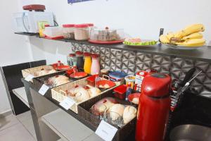 un buffet con cesti di cibo su un tavolo di Pousada Casa da Fernanda, Suíte Sky a Praia Grande Altre 17 foto
