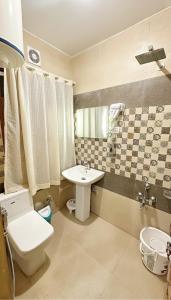 a bathroom with a toilet and a sink at Faizzy residency in Srinagar