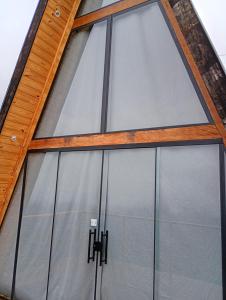 a group of glass garage doors on a building at Chalé Colinas in Campos do Jordão