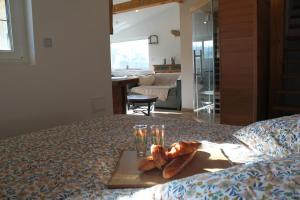 a tray of croissants sitting on top of a bed at L'Effet Mer - Côte D'Albâtre in Saint-Martin-Plage +18 photos