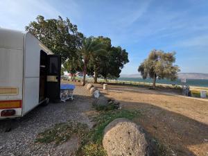 an rv parked on the side of a road at רויאל וואן in Tiberias +16 photos