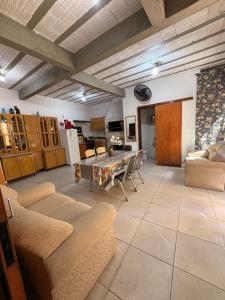 a living room with a couch and a table at Casa privada no Centro in São Gabriel