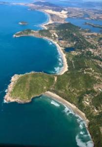 an aerial view of a group of islands in the ocean at Loft e casa Catarina in Imbituba