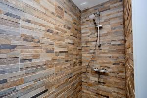 a bathroom with a brick wall and a shower at Maison spacieuse 4 chambres à Bonnard in Bonnard