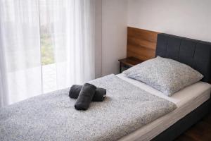 a bed with two towels on top of it at ApartDays Sarstedt in Sarstedt
