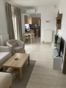a living room with a couch and a table at ArtStay-Apartment in Orestiada