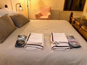 un letto con asciugamani e una pila di asciugamani sopra di The Lodge Kampi by Thea Suites 