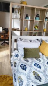 a bed with blue and white sheets and pillows at Personal blue house Madeira in Santa Cruz