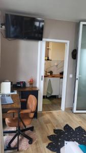 a living room with a desk and a table with a chair at Personal blue house Madeira in Santa Cruz