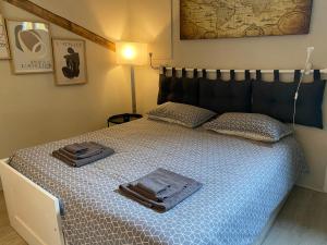 a bedroom with a bed with two towels on it at La Perla del Centro in Bologna