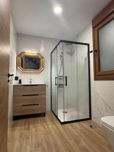 a bathroom with a glass shower and a sink at Apartamentos Rurales Sariar in Villar +45 photos