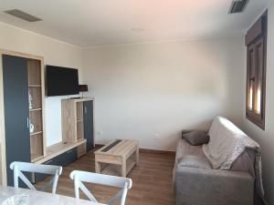 a living room with a couch and a table at Apartamentos Rurales Sariar in Villar