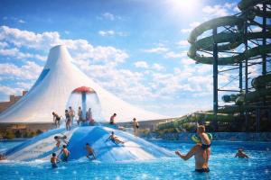 a group of people on a water slide at a water park at Piemonti Bešeňová in Bešeňová