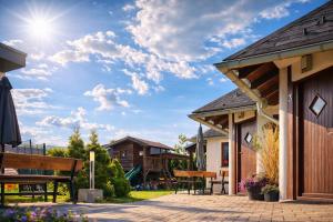 a patio at a resort with a picnic table and benches at Piemonti Bešeňová in Bešeňová