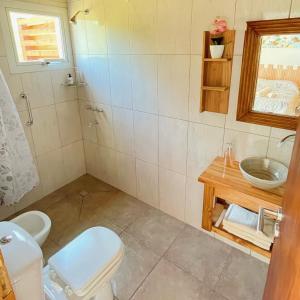 a bathroom with a toilet and a sink at Los Nenúfares in Lago Puelo +5 photos