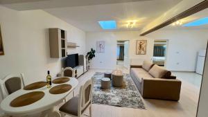a living room with a couch and a table at Parc Vatra Dornei - The 7th Haven in Vatra Dornei