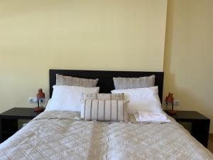 a bedroom with a bed with white sheets and pillows at Rilets Studio by BulgarianHomes in Borovets