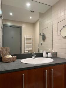 a bathroom with a sink and a mirror at Rilets Studio by BulgarianHomes in Borovets