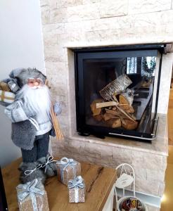 a statue of a man standing in front of a fireplace at Planinski MIR Bjelašnica in Bjelašnica