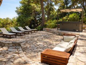 a row of benches sitting on a stone patio at Salum in Trogir