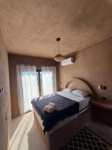 a bedroom with a large bed and a window at SAYA Coliving in El Paredón Buena Vista +37 photos